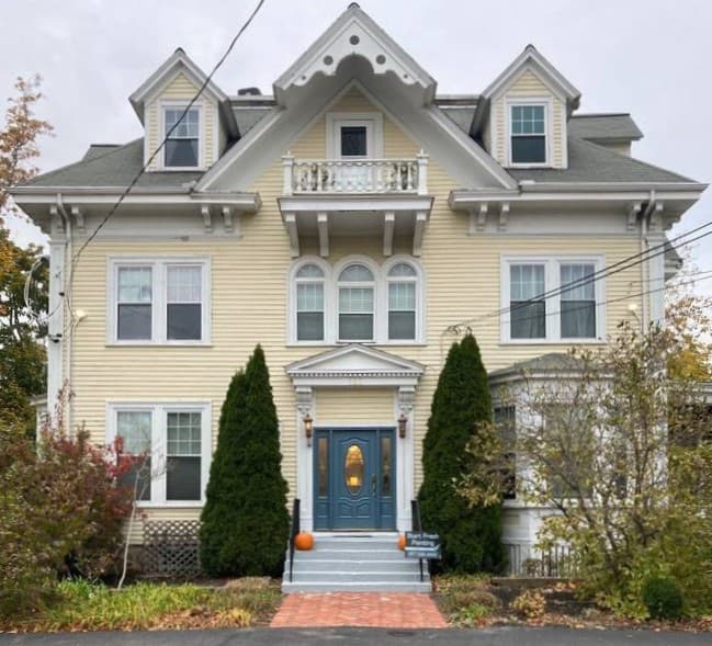 picture of a newly painted beige victorian house 